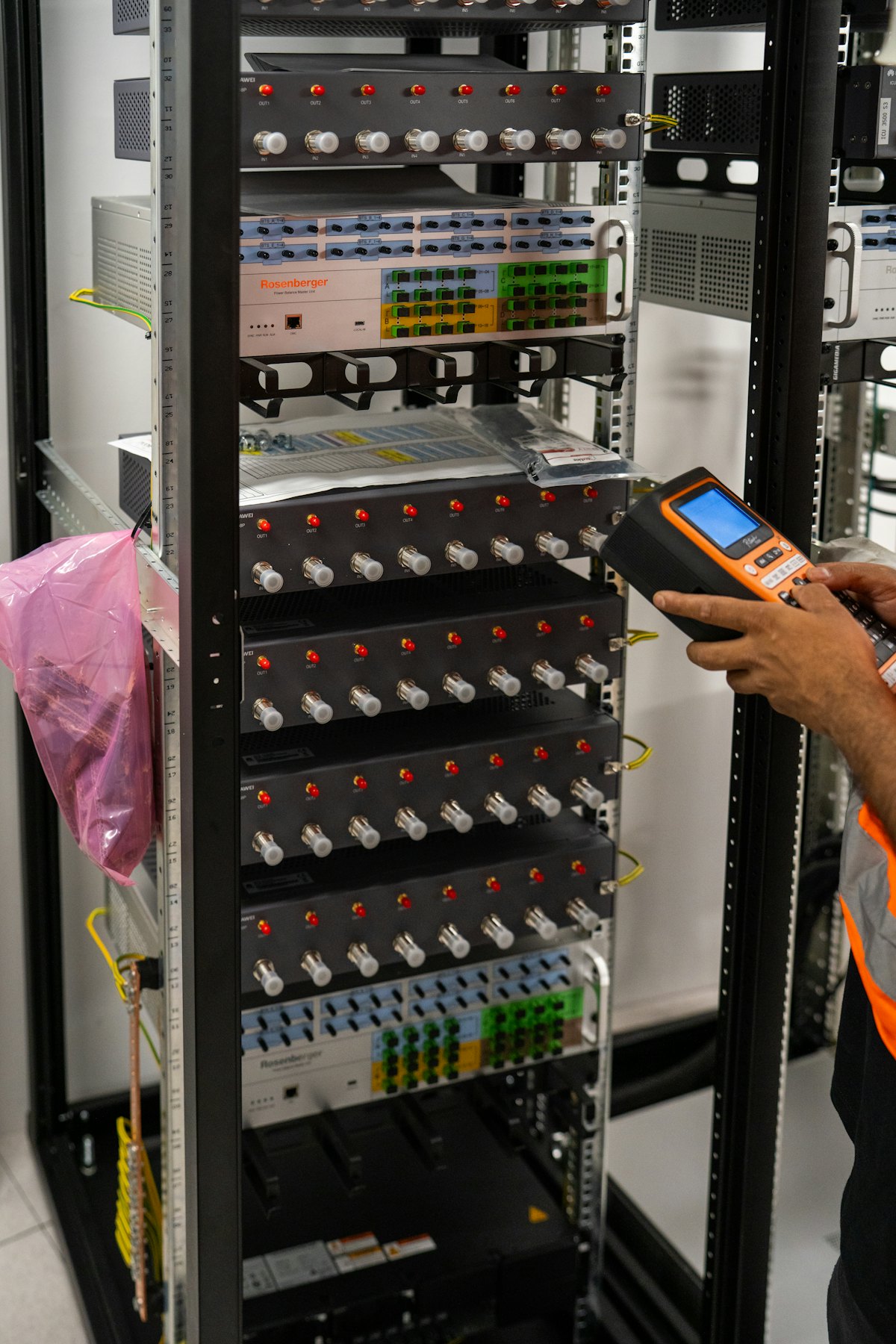A technician testing equipment in a server rack