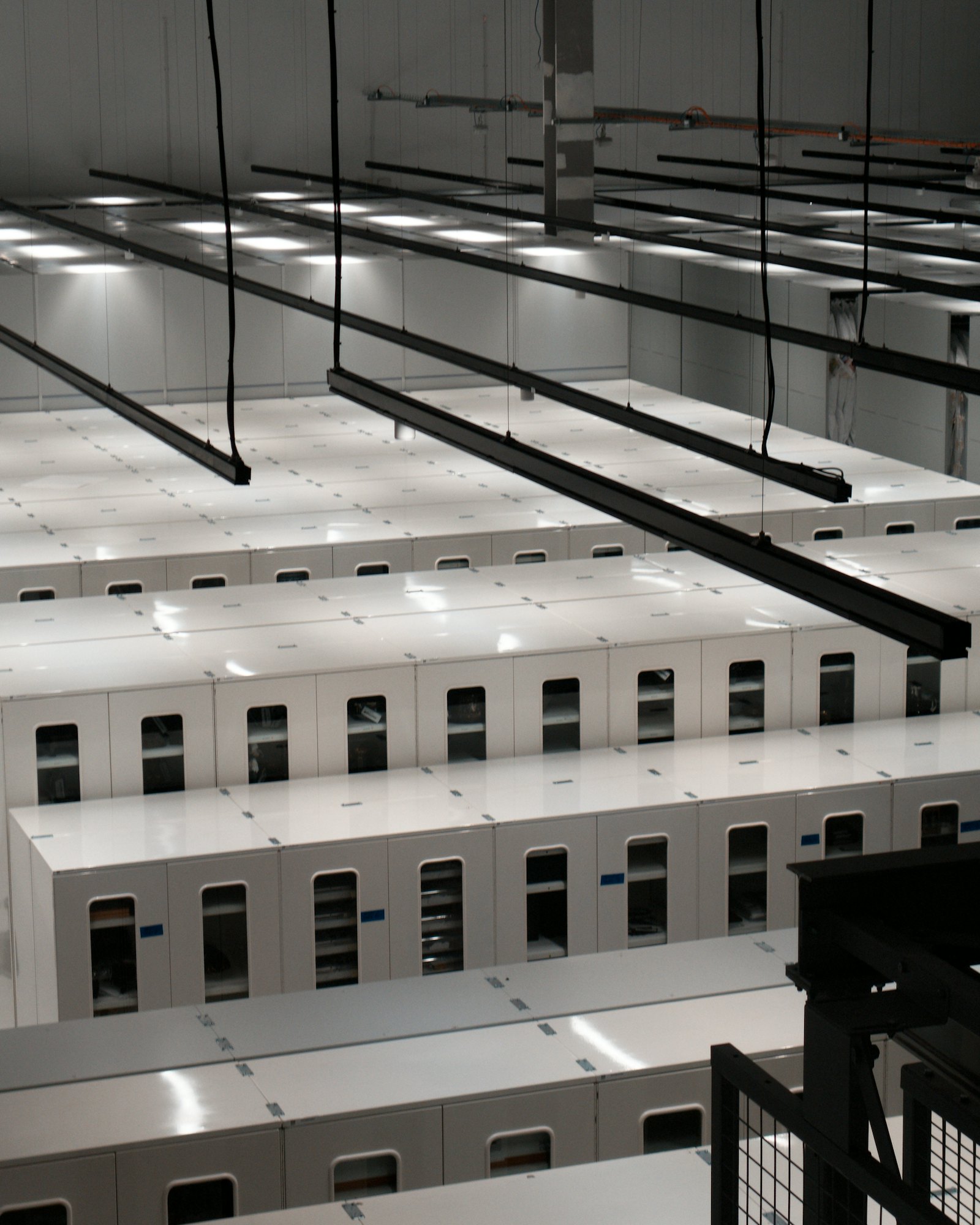 Rows of white server cabinets in a modern data hall