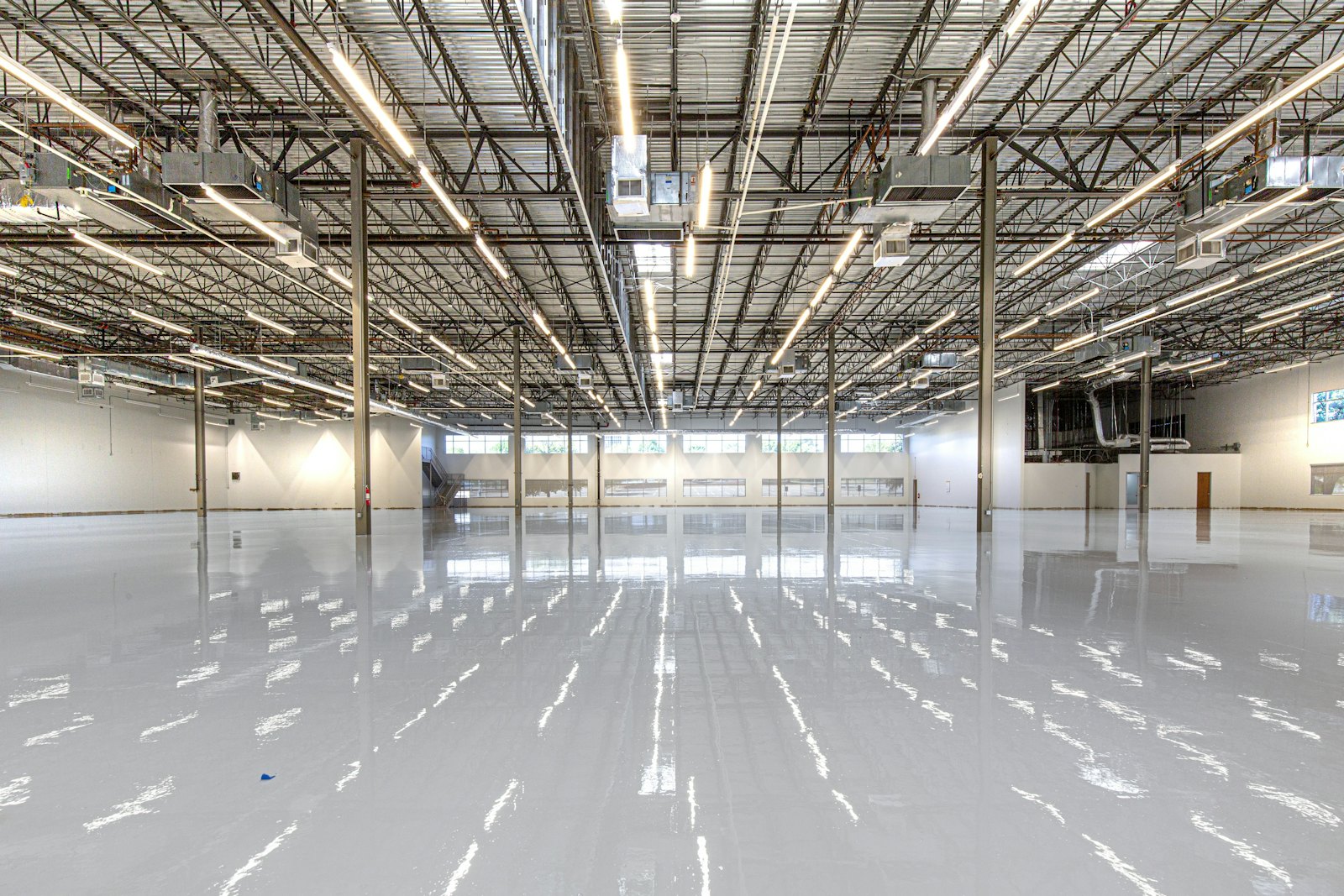 A warehouse interior lit by rows of LED fixtures